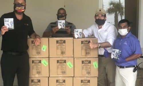 4 men standing around a stack of boxes
